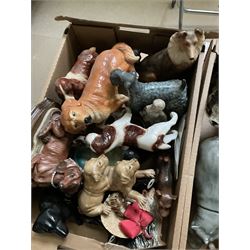 Two boxes of animal figures to include mainly ceramic and composite examples, to include dogs, lion, hippo, etc