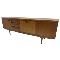 Greaves & Thomas - mid-20th century teak sideboard, fitted with three drawers, fall front compartment, and two end cupboards, on tapering supports