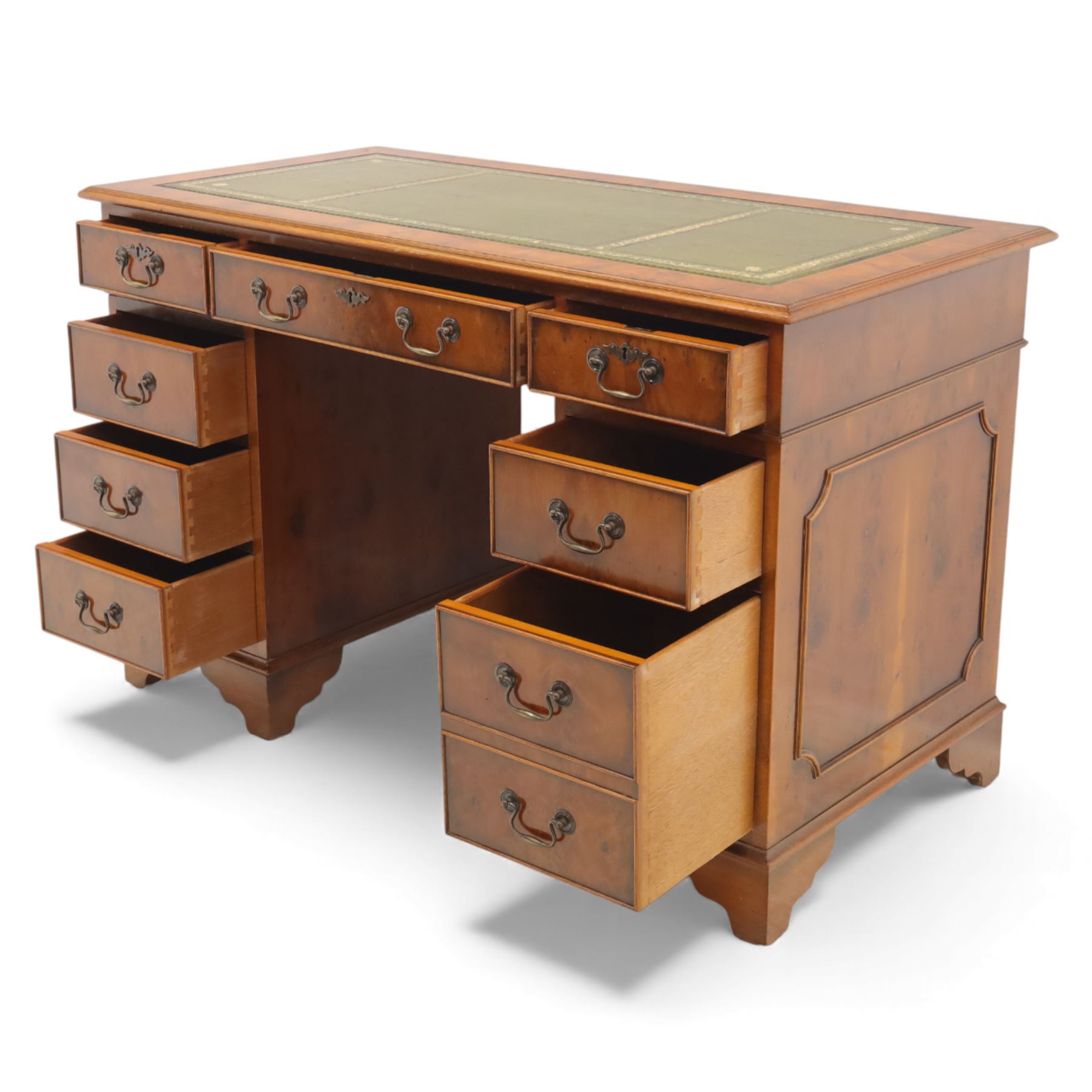 Late 20th century yew wood nine drawer writing desk, rectangular top inset with gilt-tooled green leather, above an arrangement of nine drawers with brass swan-neck handles, raised on bracket feet