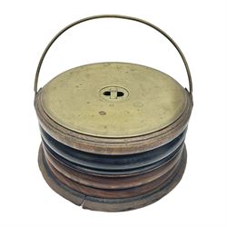  Georgian circular footwarmer with turned wood with decorative ebonised band, brass cover and swing handle, D25cm