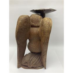 John Bunting FRBS, FRCA (1927-2002): Carved hardwood candle holder, in the form of an kneeling angel, holding aloft a copper dish, H42cm