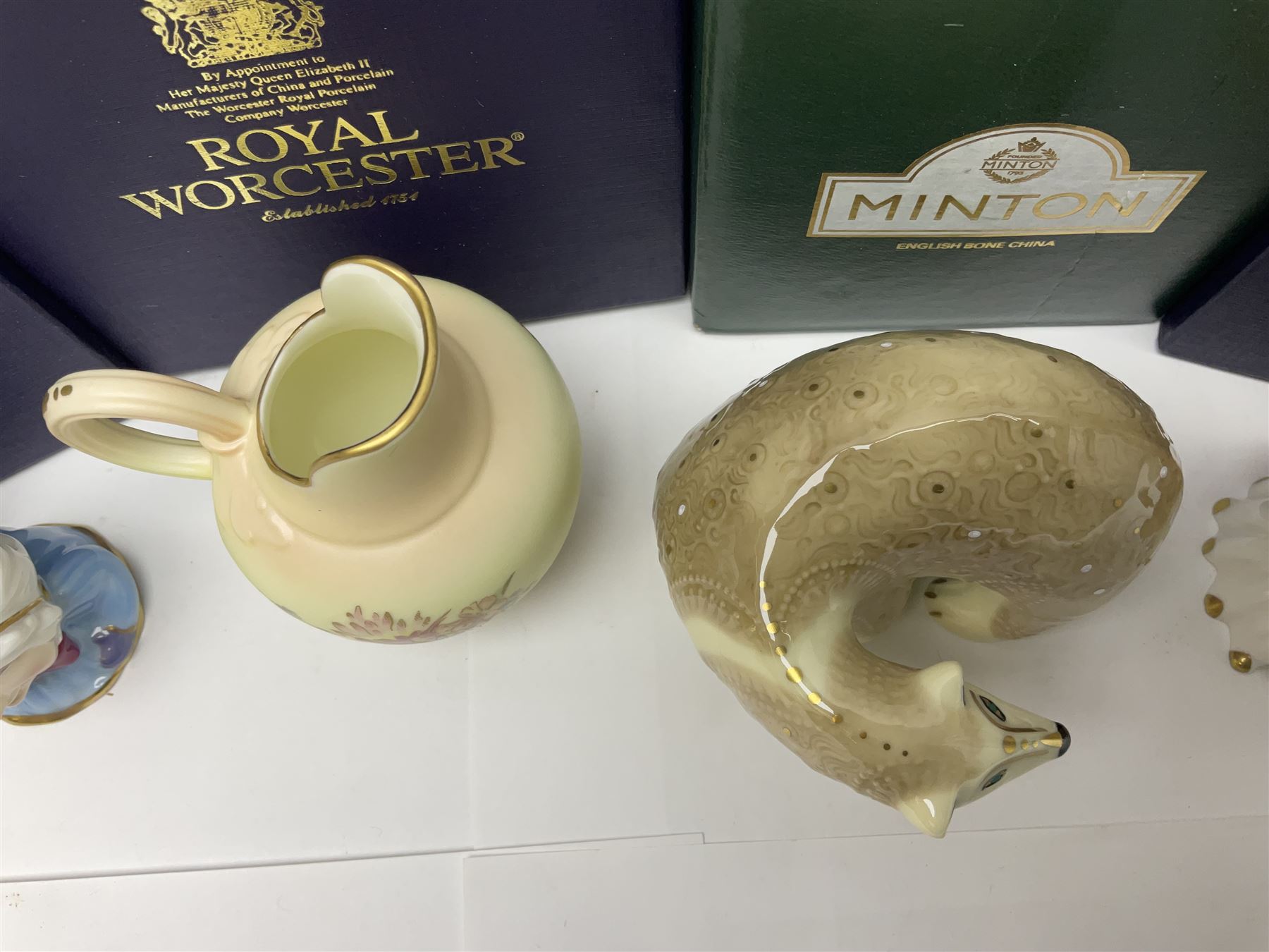 Two Royal Worcester candle snuffers from the connoisseur collection, comprising of Baby and Toby, together with Minton Fawn on Ivory Polar Bear and one other, all with original boxes 