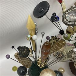 Collection of victorian and later hat pins, including a silver golf club example, hallmarked, glass and sequin examples, with various pin cushions  