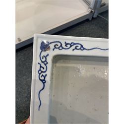 Chinese blue and white planter and stand, each of square slightly tapering and flared form, the planter decorated with two dragons and blossoming peonies, between stylised borders, the stand decorated with flower heads and vines, planter H30cm W29cm, stand H7cm D28.5cm