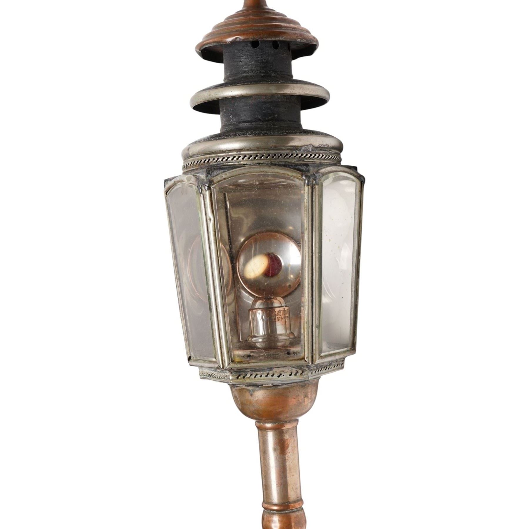 J Marston & Co. Ltd. (Birmingham) - pair of Victorian copper glazed and white metal carriage lamps with toleware outer-body, hexagonal body with faceted bevelled glass and reflective panels one inset with circular red reverse light, surmounted by a turned copper finial over a pagoda form chimney, raised on turned copper spoke, maker engraved to candle mount
