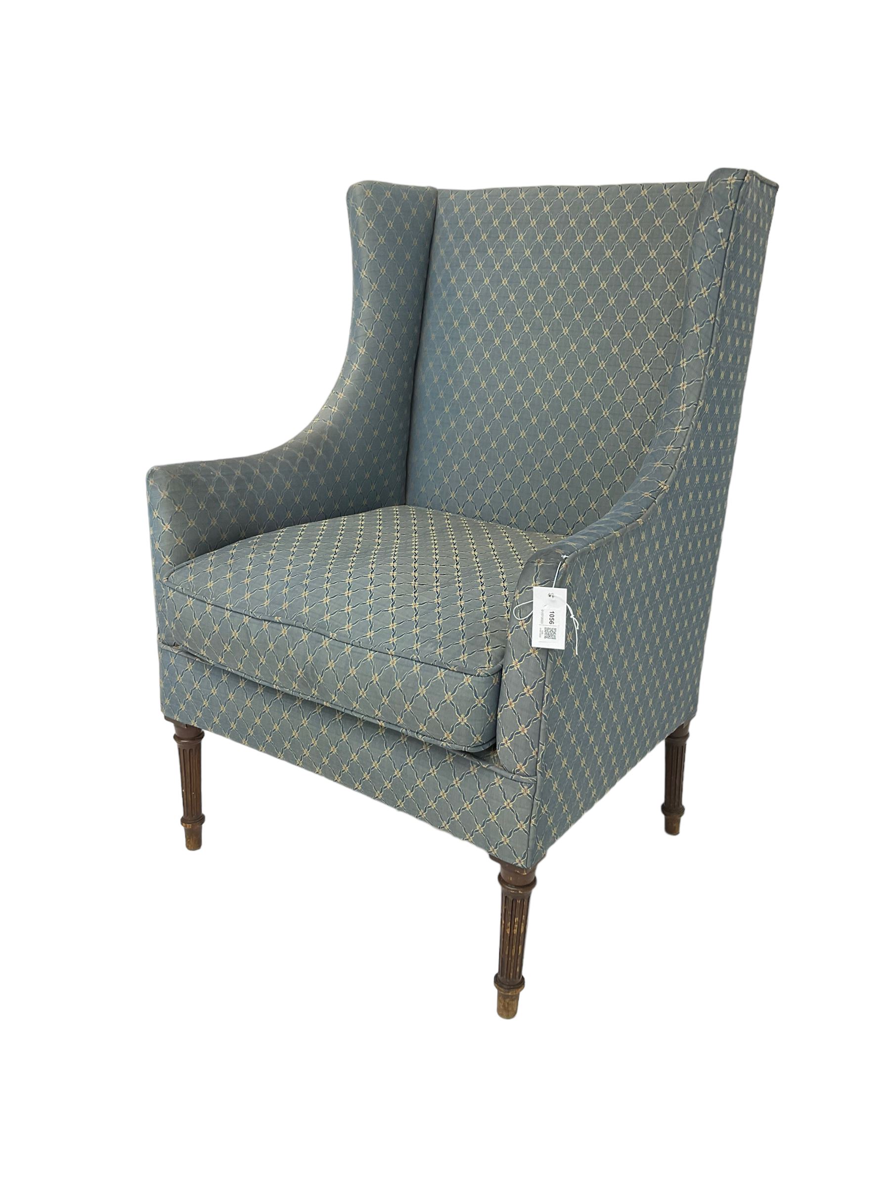 Early 20th century high wing back armchair upholstered in pale