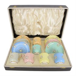 Spode six coffee cups and saucers cased set, decorated with floral sprigs on a polka dot g...