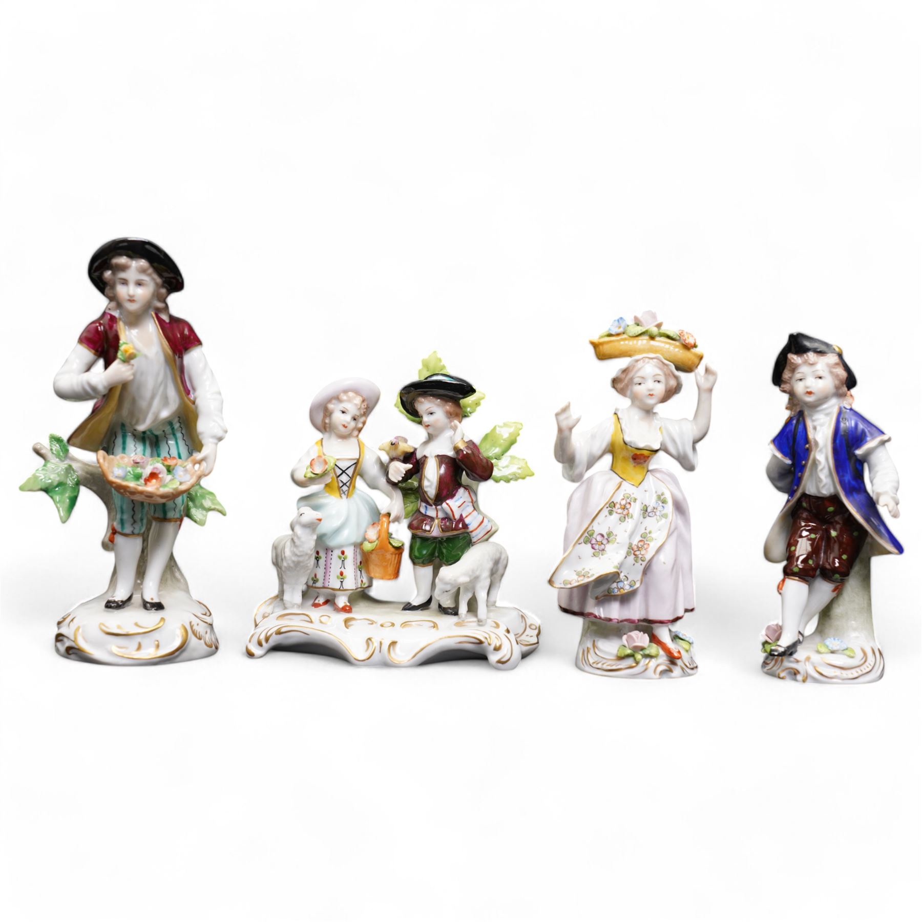 Group of Sitzendorf porcelain figures, one modelled as two children with birds and lambs, the others holding and offering flowers, each upon gilt detailed base, with painted marks beneath (4)