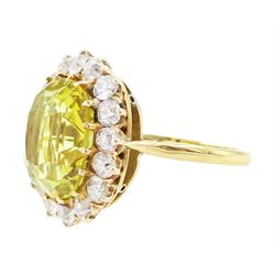 Early 20th century gold chrysoberyl and diamond cluster ring, single cushion cut yellow / green chrysoberyl of approx 8.00 carat, surrounded by sixteen old cut diamonds, stamped 18ct, total diamond weight approx 1.10 carat