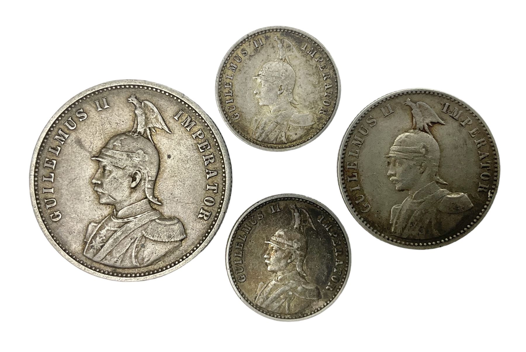 German East Africa 1892 one rupie, 1906 half rupie, and two quarter rupie coins dated 1910, 1913