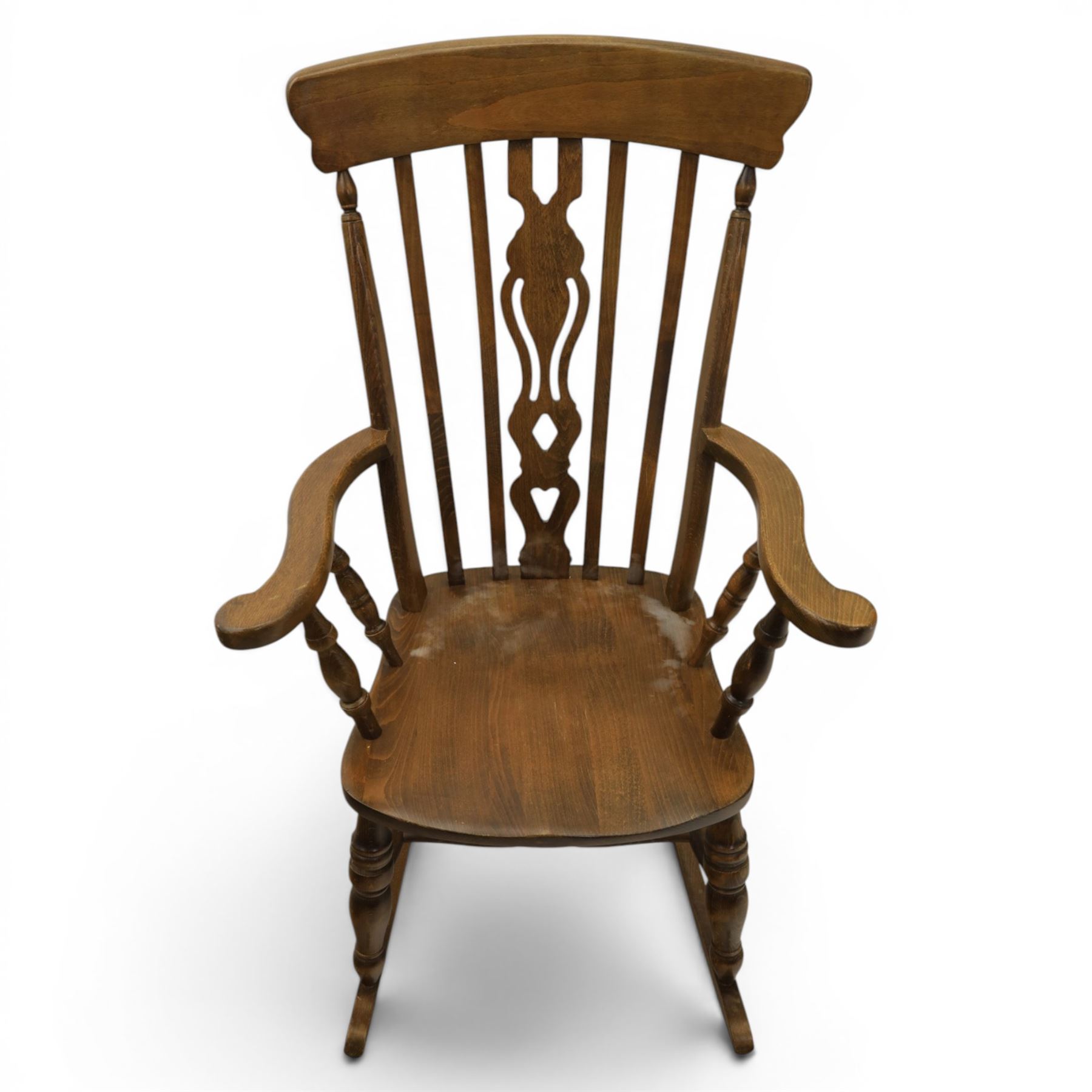 Farmhouse elm rocking chair, high back with 'Fleur De Lis' splat, shaped arms above turned supports, on rocker base 