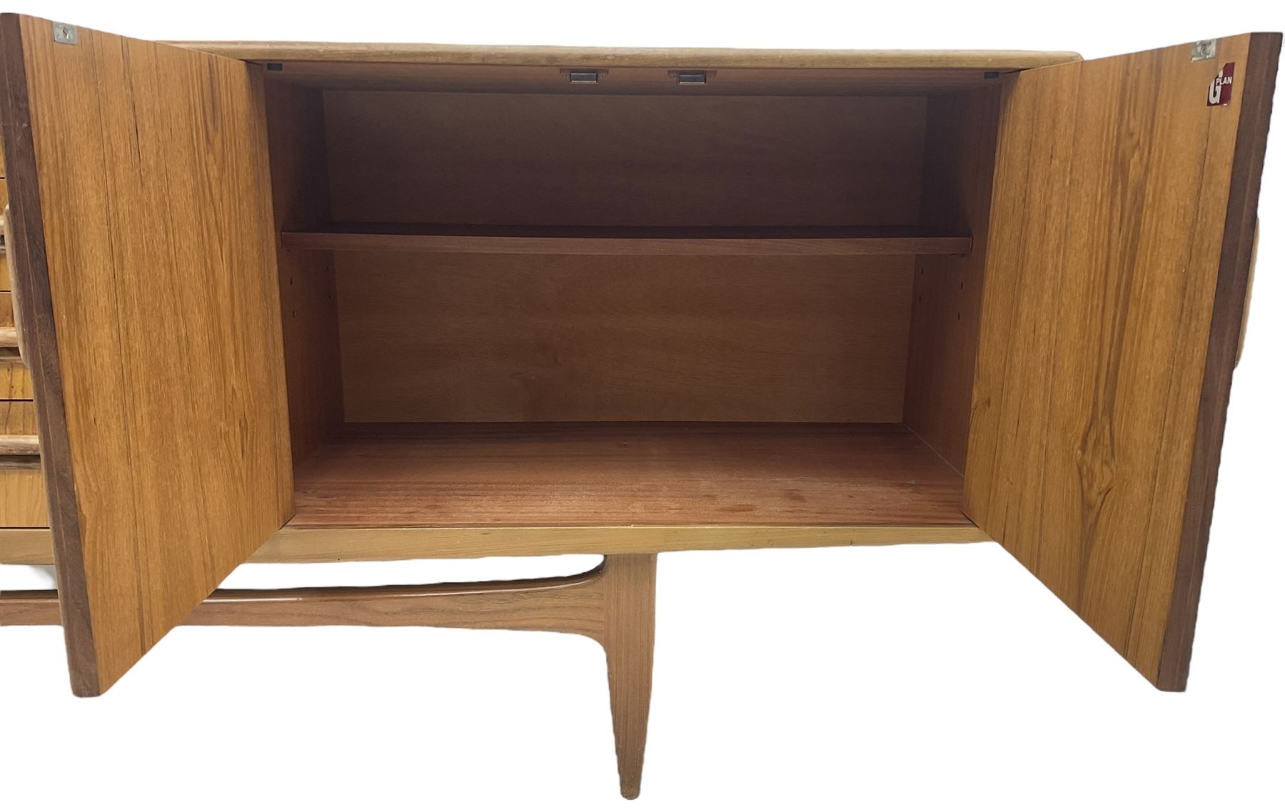 G-Plan – teak sideboard, four central drawers flanked by two double cupboards, enclosed by panelled doors 