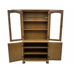 Victorian polished pine bookcase on cupboard, two glazed doors above two panelled cupboards