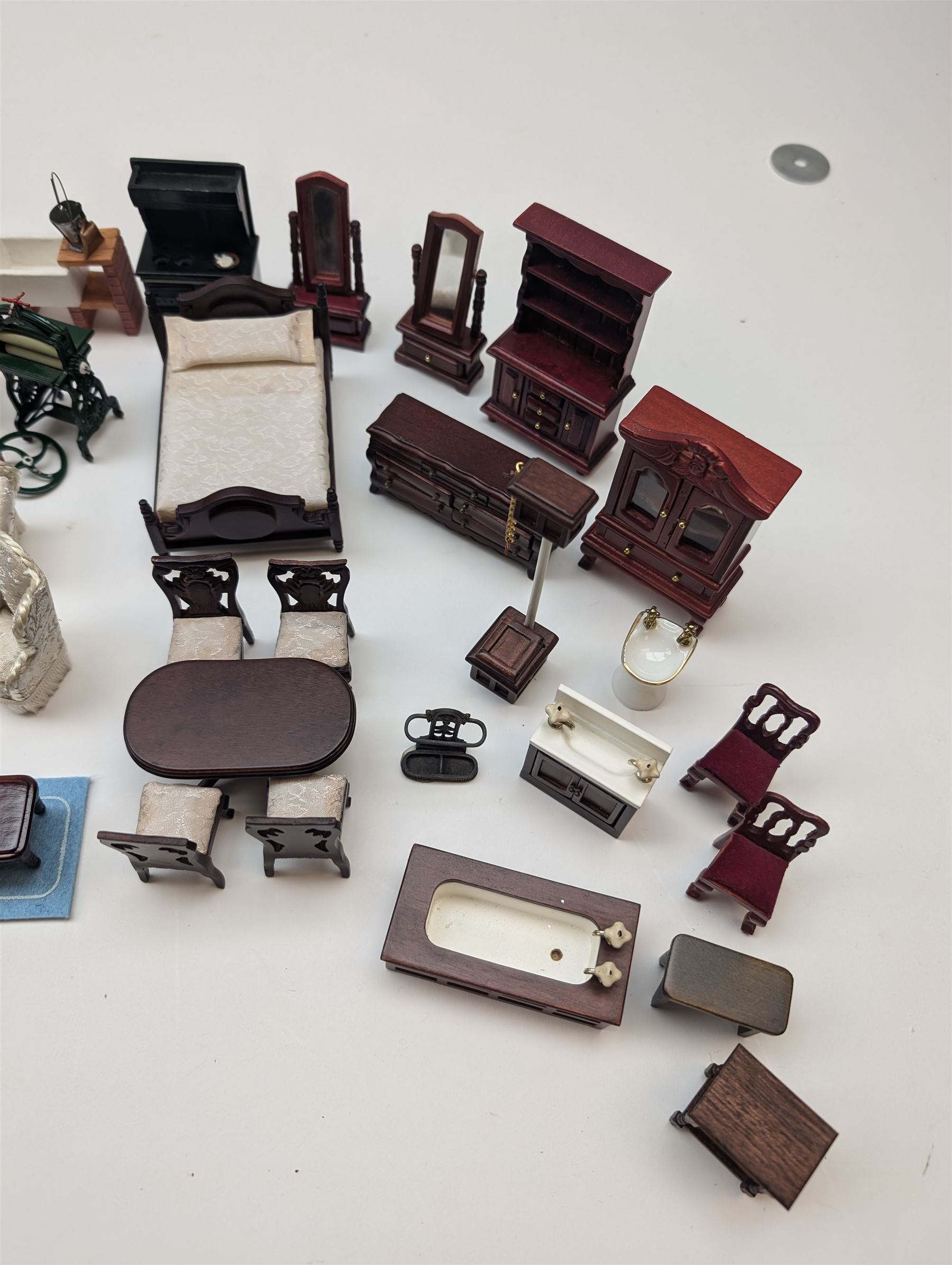 1:24 scale dolls house furniture, comprising stove, mangle, couch and arm chairs, bed, bathroom suite, two dining tables with chairs, side tables, cabinets, dressers, etc 