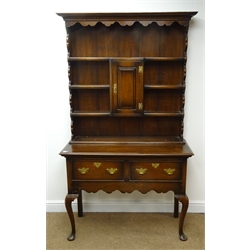  Early 20th century oak dresser, projecting cornice, four plate racks with central cupboard, two drawers, shaped apron, cabriole legs, pad feet, W110cm, H186cm, D41cm  