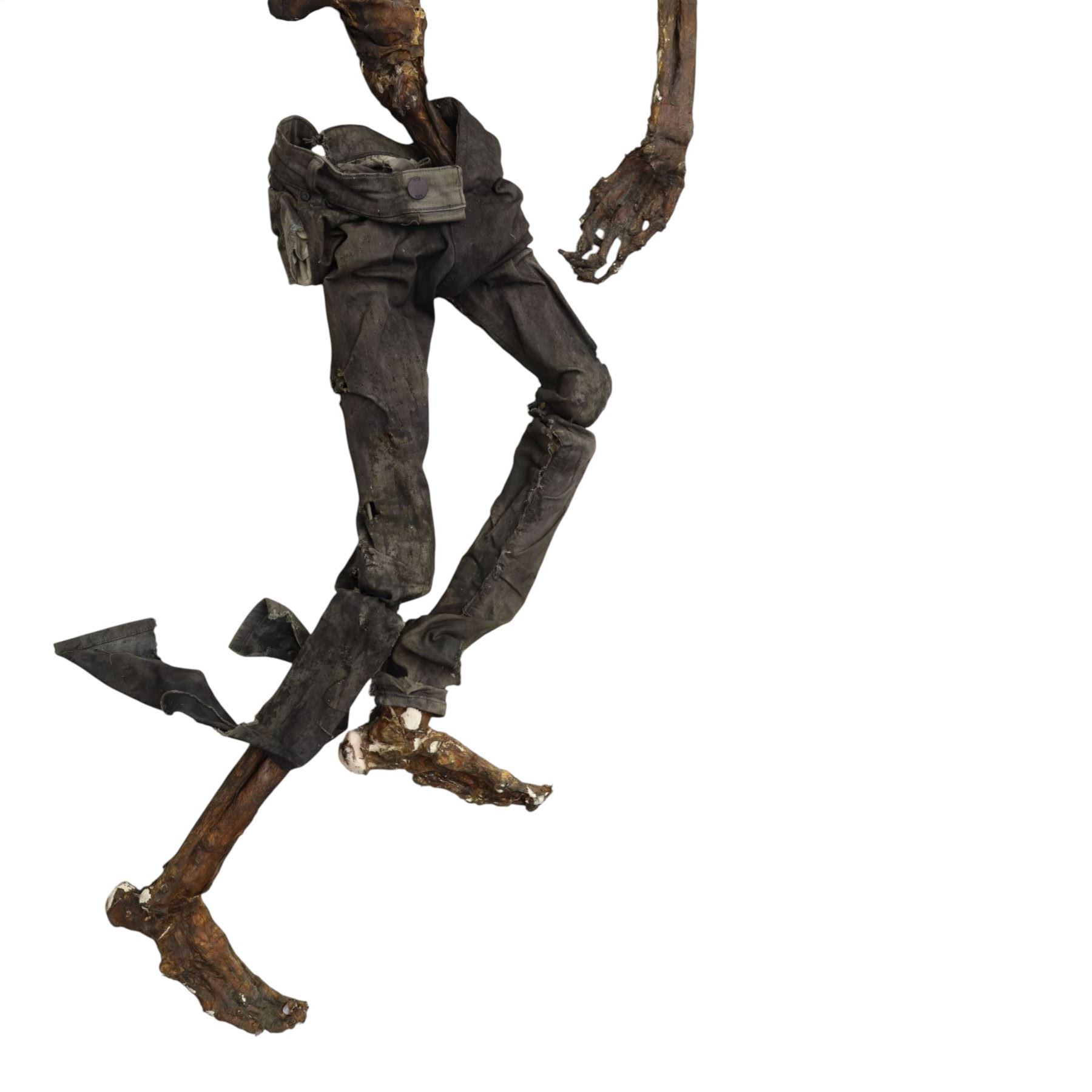 FILM PROPS; four decomposing prop cadavers, each with articulated joints and limbs, likely from a TV or film production, each prop displays intricate detailing with realistic aging and weathering, with a body bag