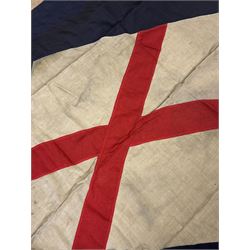 Ship's house flag, rectangular linen flag, with a white diamond and red cross to the centre, upon a cobalt blue ground, inscribed on the hoist 'Cutty Sark', H130cm, W170cm

Provenance by vendor repute: Vendor's father was a naval cadet in 1940s/50s on board HMS Worcester which was moored alongside the Cutty Sark on the River Thames at Greenhithe. He has had the flag since then. 