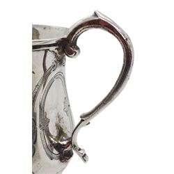 Victorian silver christening mug, of waisted form with scroll handle, the body engraved with strapwork type motifs, upon a circular spreading foot with beaded edge, hallmarked Charles Boyton (II), London 1863, including handle H10cm, approximate weight 3.42 ozt (106.5 grams)