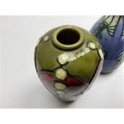 Minton Secessionist vase, with tube-lined stylised flower head decoration on a blue ground, printed mark to base 'Minton Ltd, No. 30', together with another Minton Secessionist tubelined vase,  printed mark to base 'Minton Ltd, No. 16', tallest example H13.5cm