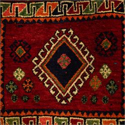 South West Persian Qashgai saddlebag, (Khorjin), woven in geometric designs with central lozenge medallions on a rich madder red ground, decorated with tribal motifs in indigo, ivory green, and ochre, the reverse  with panels of stripped flatwoven kilim 