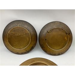 Two oil painted chargers decorated with joyful gentleman, both signed W Stanley, together with a Musterschutz charger decorated in high relief