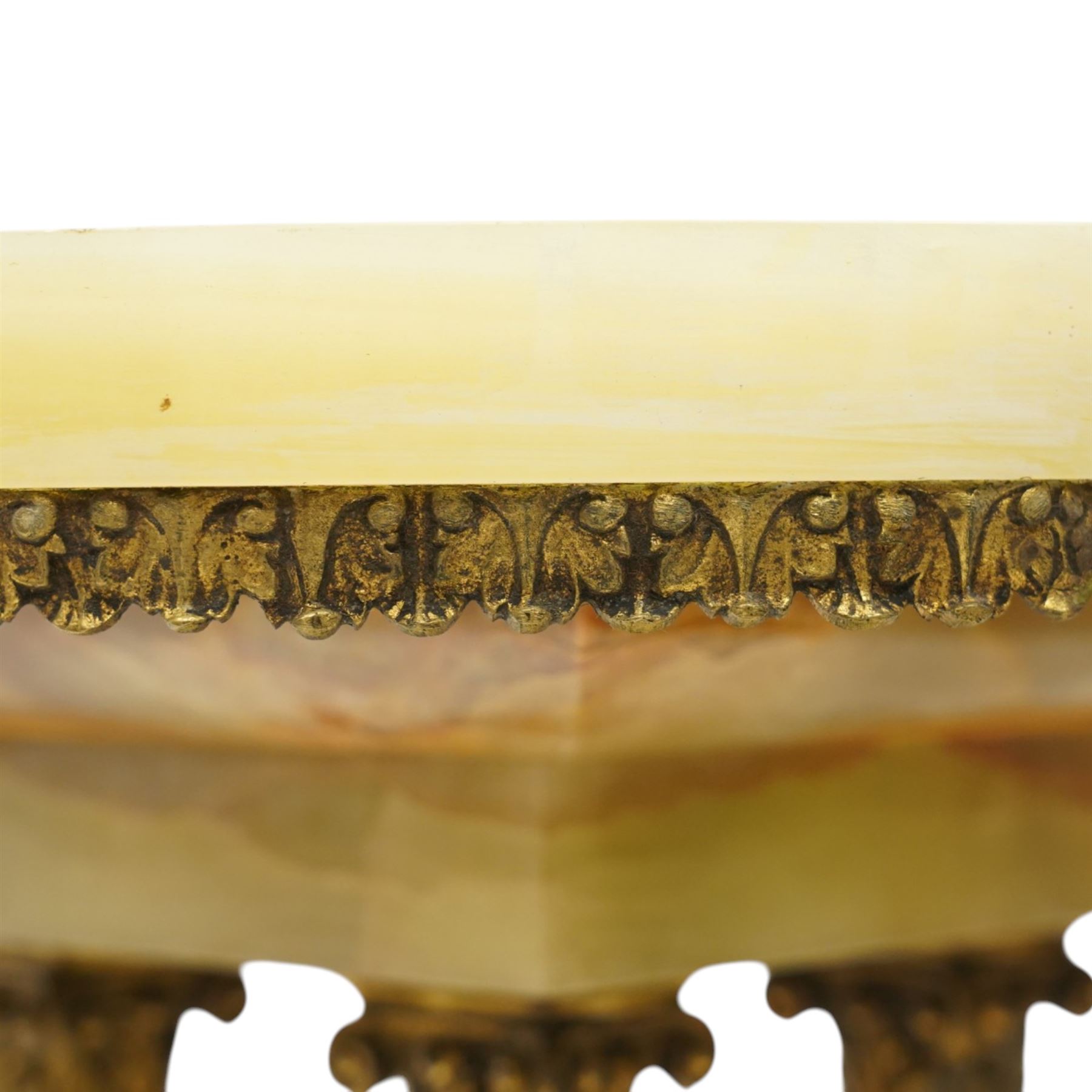 Neoclassical onyx and brass jardinière or plant stand, circular onyx top over an acanthus gilt frieze, supported by for fluted composite columns, square plinth with applied rosette mounts and stepped base, raised on scroll feet  