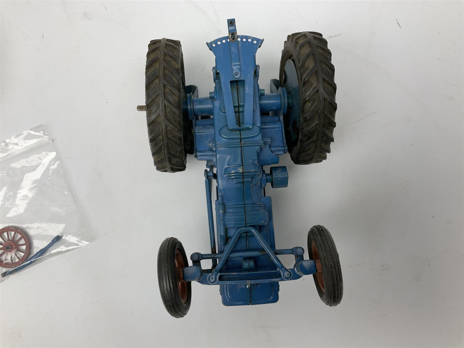 Chad Valley clockwork Fordson Major Tractor, a group of play worn Britains and other lead and metal farm animals, figures and accessories including a kennel, haystacks, dovecote, cows, sheep etc, together with a diecast model of a Tandem Bike L31cm