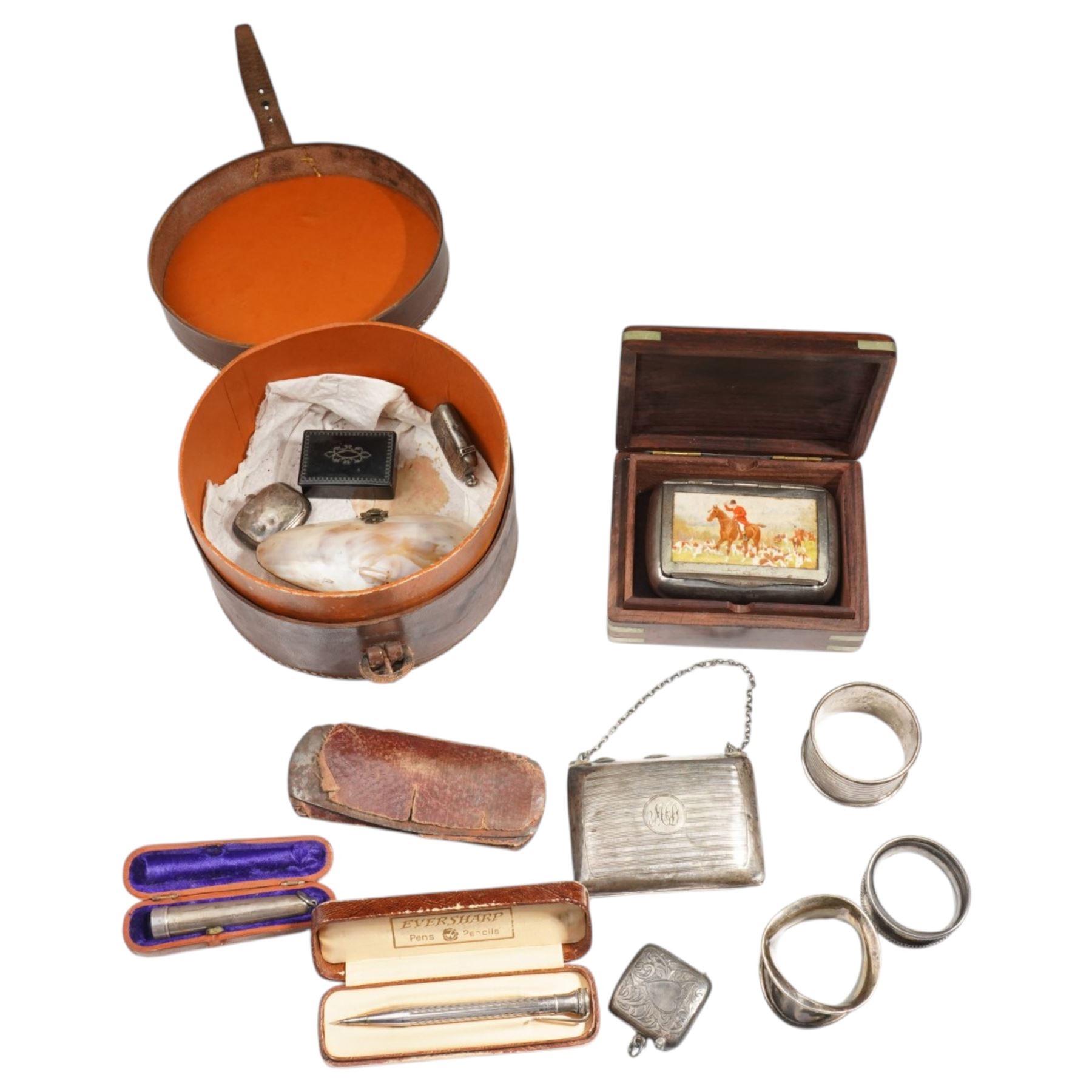 Collection of silver items including purse, three napkin rings, two vesta cases, silver cheroot holder case etc