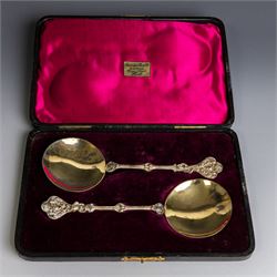 Pair of late Victorian silver serving spoons, each with circular gilt bowls and embossed p...