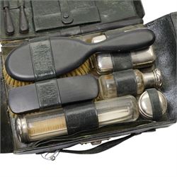 Set of six dessert knives and forks with silver collars and mother of pearl handles, silver plated photograph frame and travelling toilet set in leather case