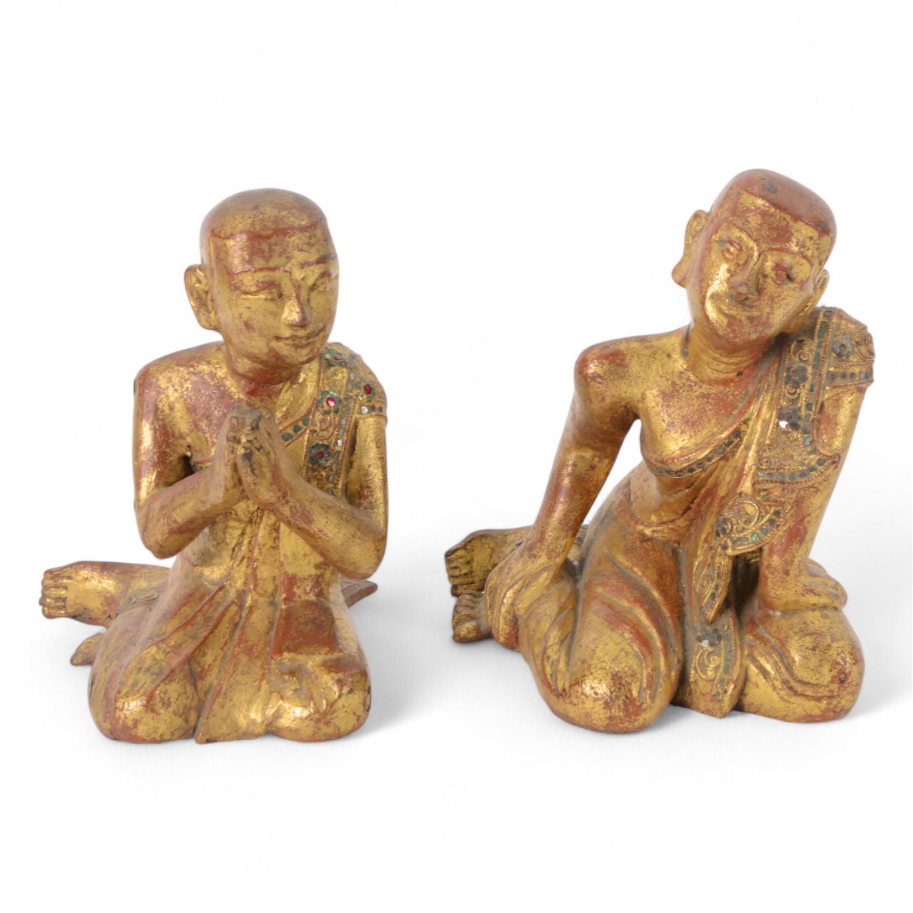 Late 19th century two Burmese Mandalay lacquered and gilt wood figures of monks, the robes edged with colored glass inlay and leafy scroll bands in raised lacquer, H25cm