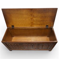 Late 20th century oak linenfold blanket box, with hinged rectangular top opening to a plain interior, the front carved with three linenfold panels, plain panelled sides, raised on stile supports