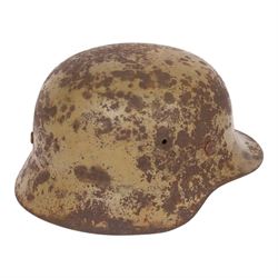 WWII German Third Reich M1940 helmet, with desert camouflage, the left inner brim stamped SE64, the back inner brim stamped 506, with leather eight tongue liner, together with German M34 helmet