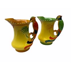 Two Burleigh Ware 1930's Parrot jugs, hand painted with butterfly design upon a yellow ground, with handles in the form of parrots, H19cm, together with a Lladro figure Pretty Pickings, model no 5222, H18.5cm, a group of 20th century Belleek vases and dishes, etc. 