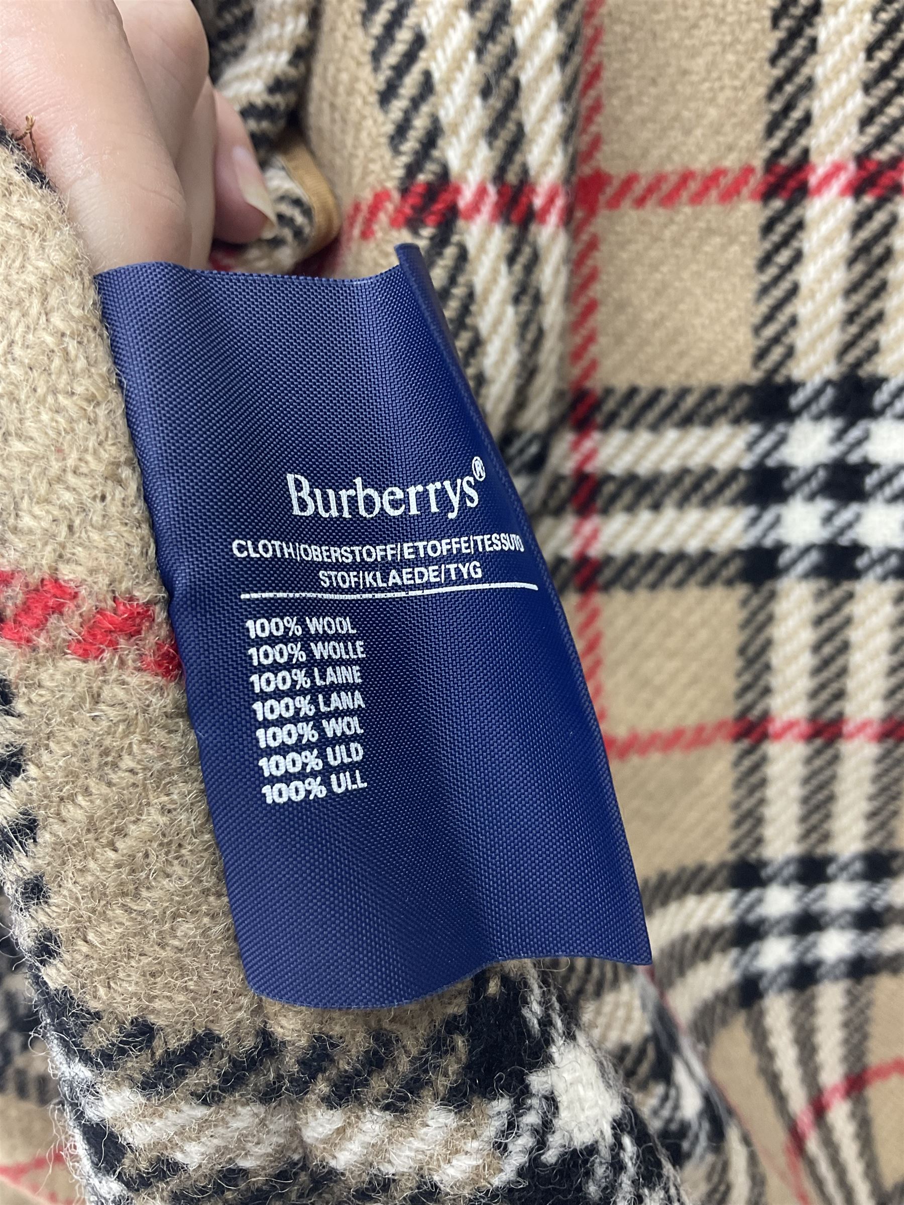 Ladies Burberry double breasted trench coat, with belt and detachable woollen gilet, in traditional cream colour with Burberry check lining, together with a gentlemans Burberry single breasted trench coat, both L112cm