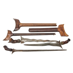  Malay Kris with 36cm shaped curved blade with cast metal mounted carved hardwood handle, another similar with 35cm blade and brass mounted carved hardwood handle, another with 49cm straight blade, all in wooden sheaths  