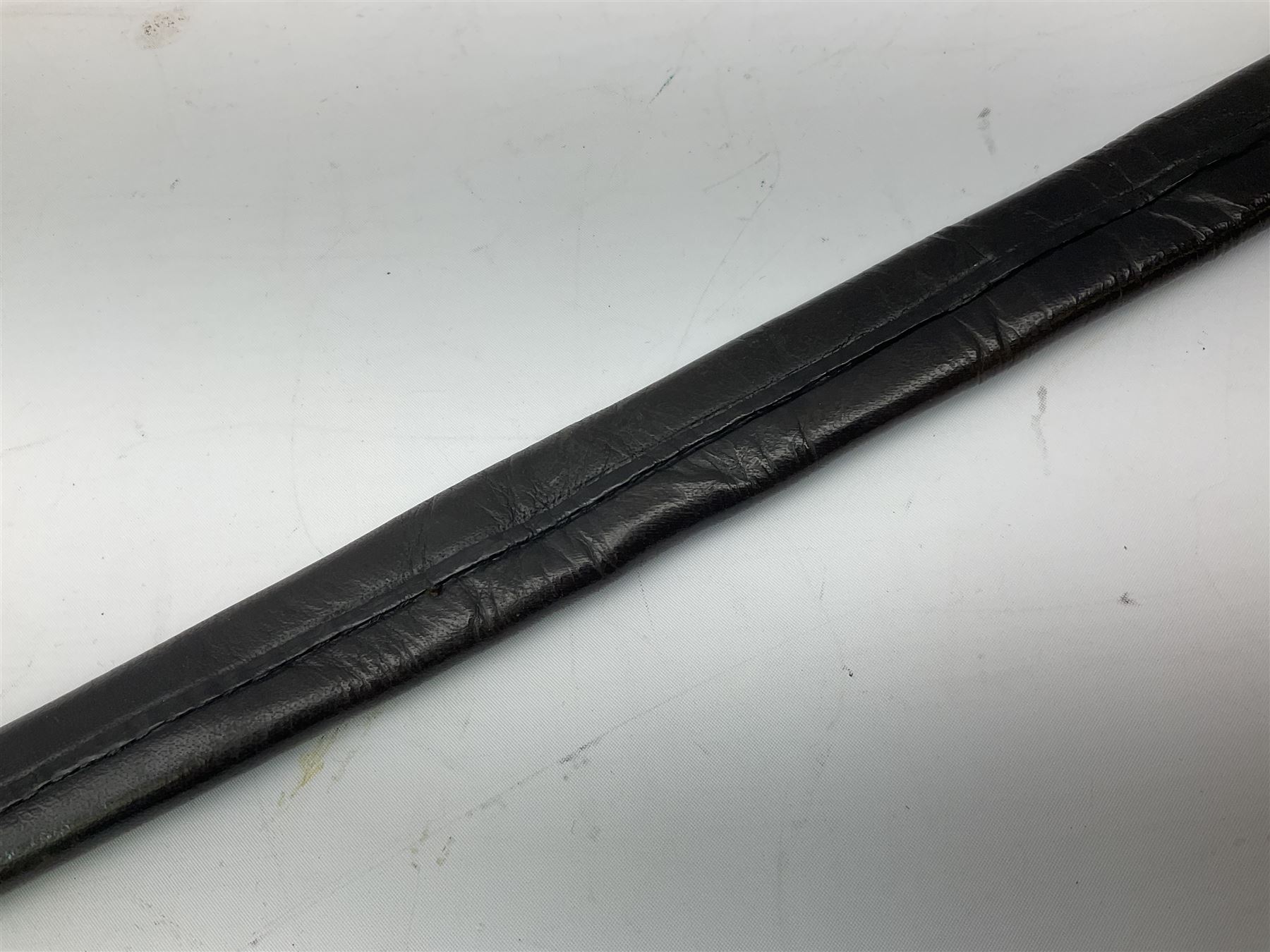 Five-ball spadroon sword with 78.5cm fullered steel blade and brass hilt with fluted swollen grip; in brass mounted leather scabbard, the locket with traces of the makers name John Knubley 11 Charing Cross L97.5cm overall