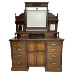 Edwardian mahogany dressing chest, raised triple mirror back with bevelled plates and fluted decoration over two trinket drawers, the base fitted with two central cupboards flanked by four graduating drawers to each side