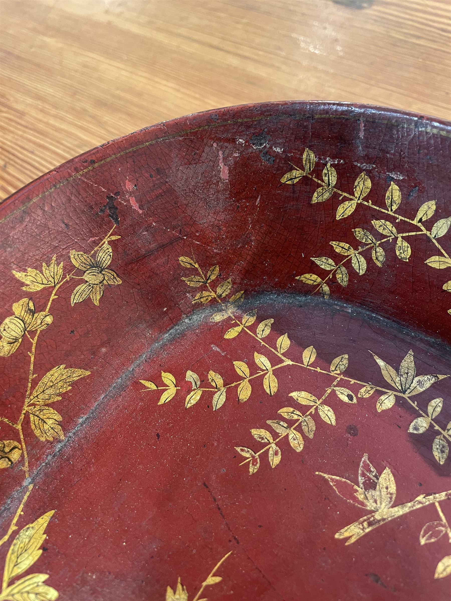 Early 19th century red lacquered papier-mâché tray by Clay of King Street Covent Garden, of rounded rectangular form, painted in gilt with large foliate sprays and butterflies, impressed verso CLAY KING ST COVENT GARDEN, W66.5cm D48.5cm