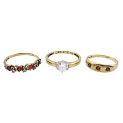 Gold single stone cubic zirconia ring engraved, three stone gypsy set garnet ring and one other garnet and cubic zirconia ring, all hallmarked 9ct 