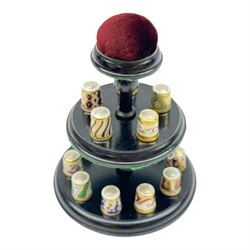 Collection of fifteen Royal Crown Derby thimbles upon an ebonised display stand, together with Royal Crown Derby candle snuffer in Imari pattern 1128