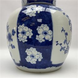Chinese blue and white ginger jar, painted with bamboo and blossoming trees in panels against a flowerhead ground, H24cm