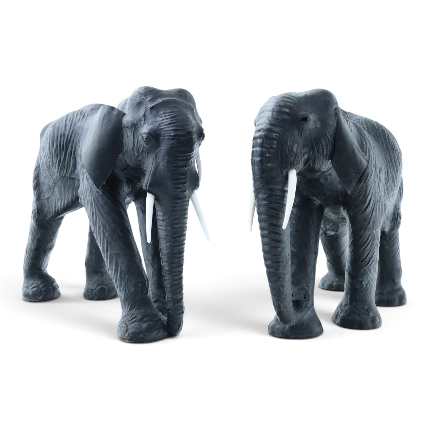 In the style of Liberty & Co - pair of 20th century ebonised leather elephants