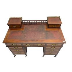 Maple & Co - Edwardian mahogany twin pedestal desk, the raised back with spindle gallery and open shelf to centre flanked by two trinket drawers, rectangular top with inset writing surface, fitted with one long and eight short graduating drawers flanked by fluted uprights, raised on brass and ceramic castors, stamped to central drawer