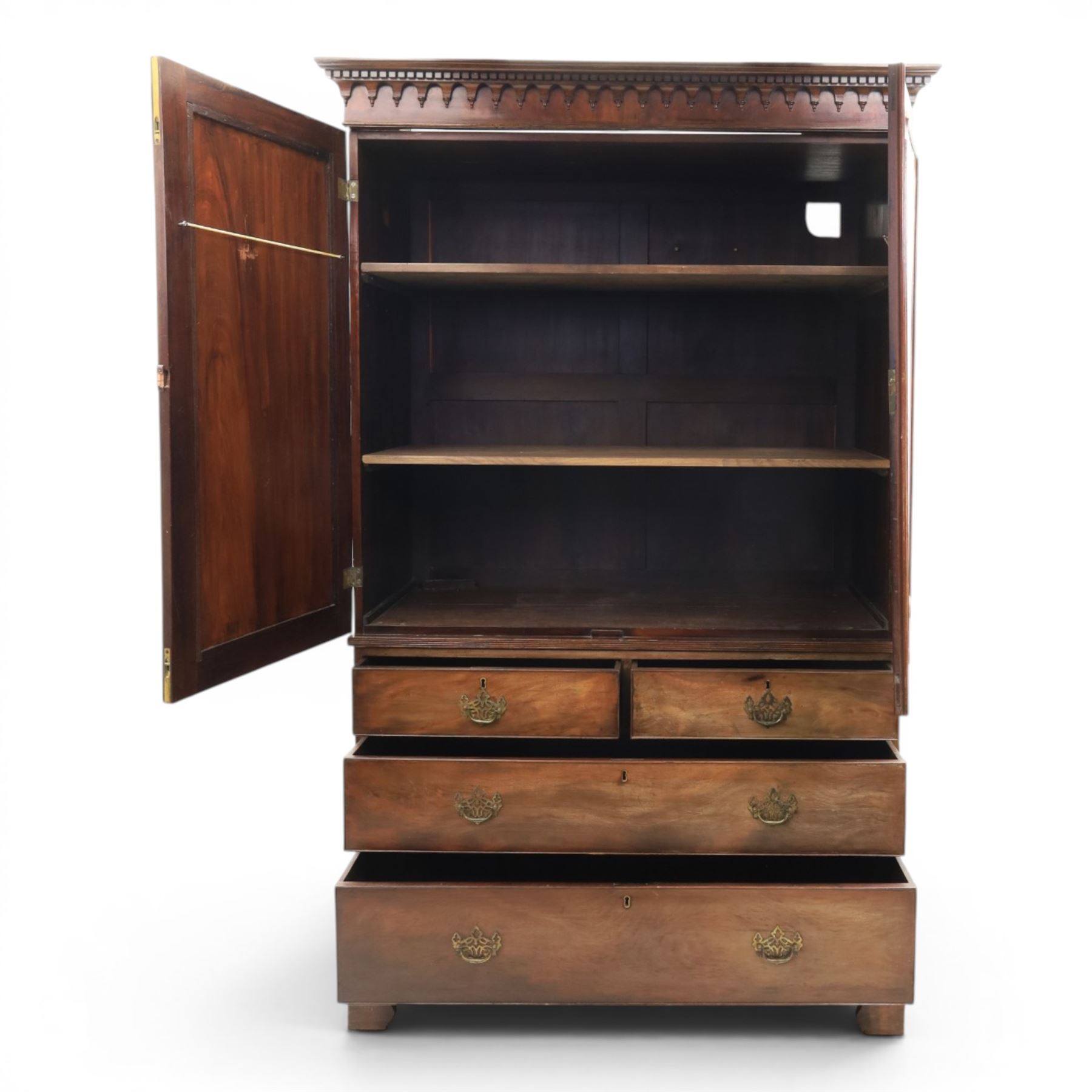 George III mahogany linen press, projecting dentil cornice, moulded doors enclosing a shelved interior, above a lower section with two short over three long drawers, raised on bracket feet 