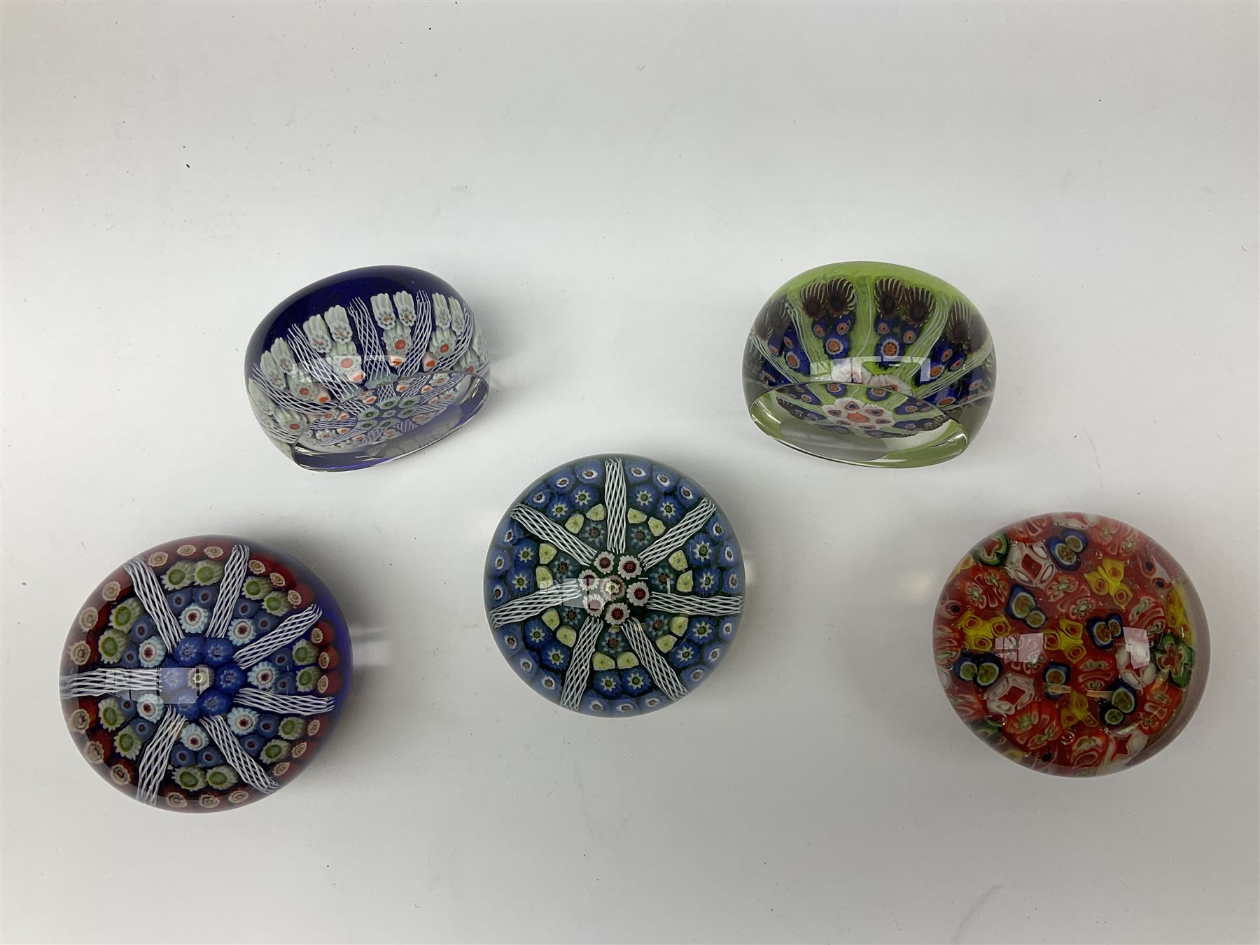 Five Millefiori glass paperweights, of differing designs, predominately by Strathearn