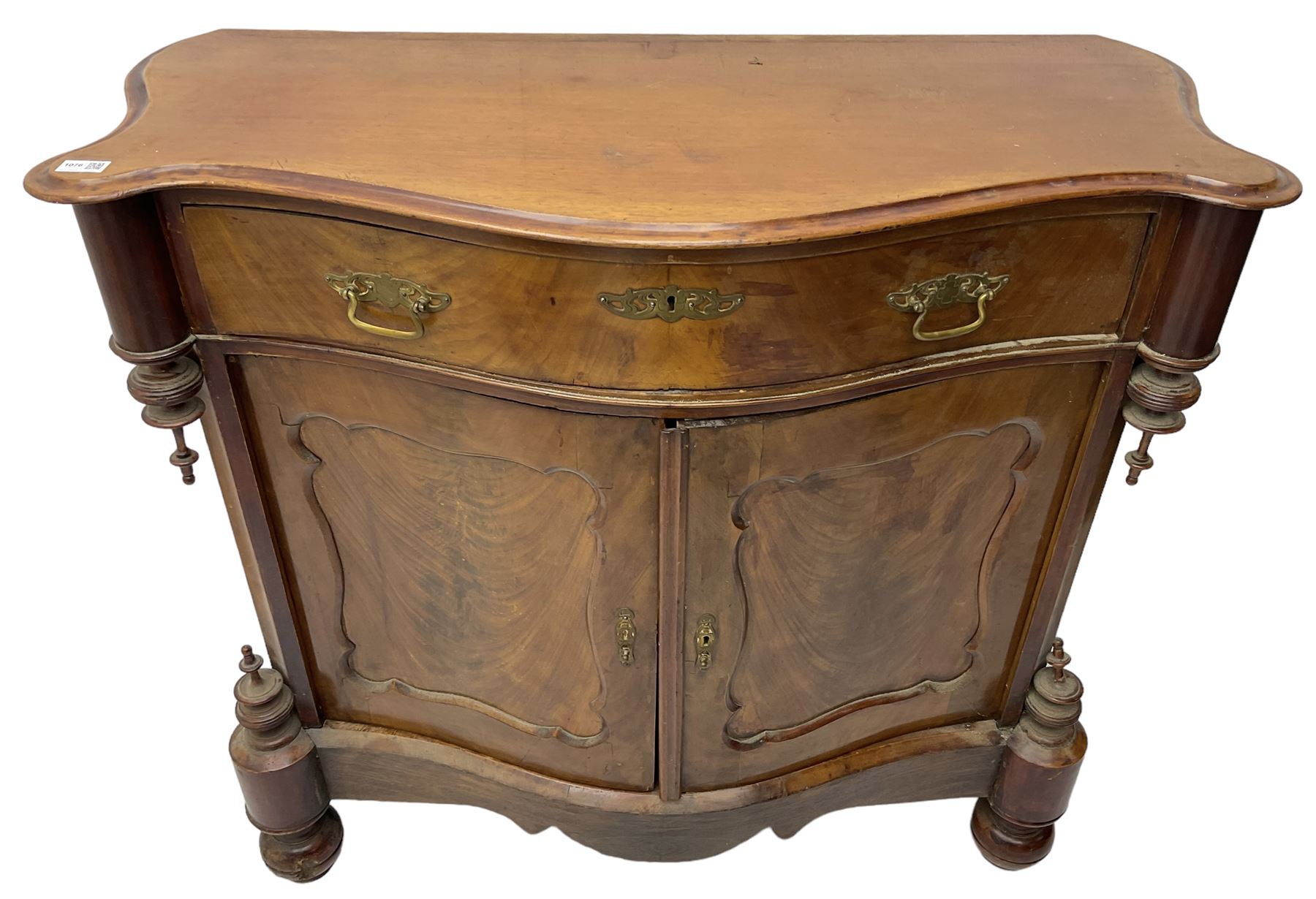 Victorian mahogany serpentine side cabinet, fitted with single drawer over panelled cupboard enclosing single shelf, raised on turned bun feet