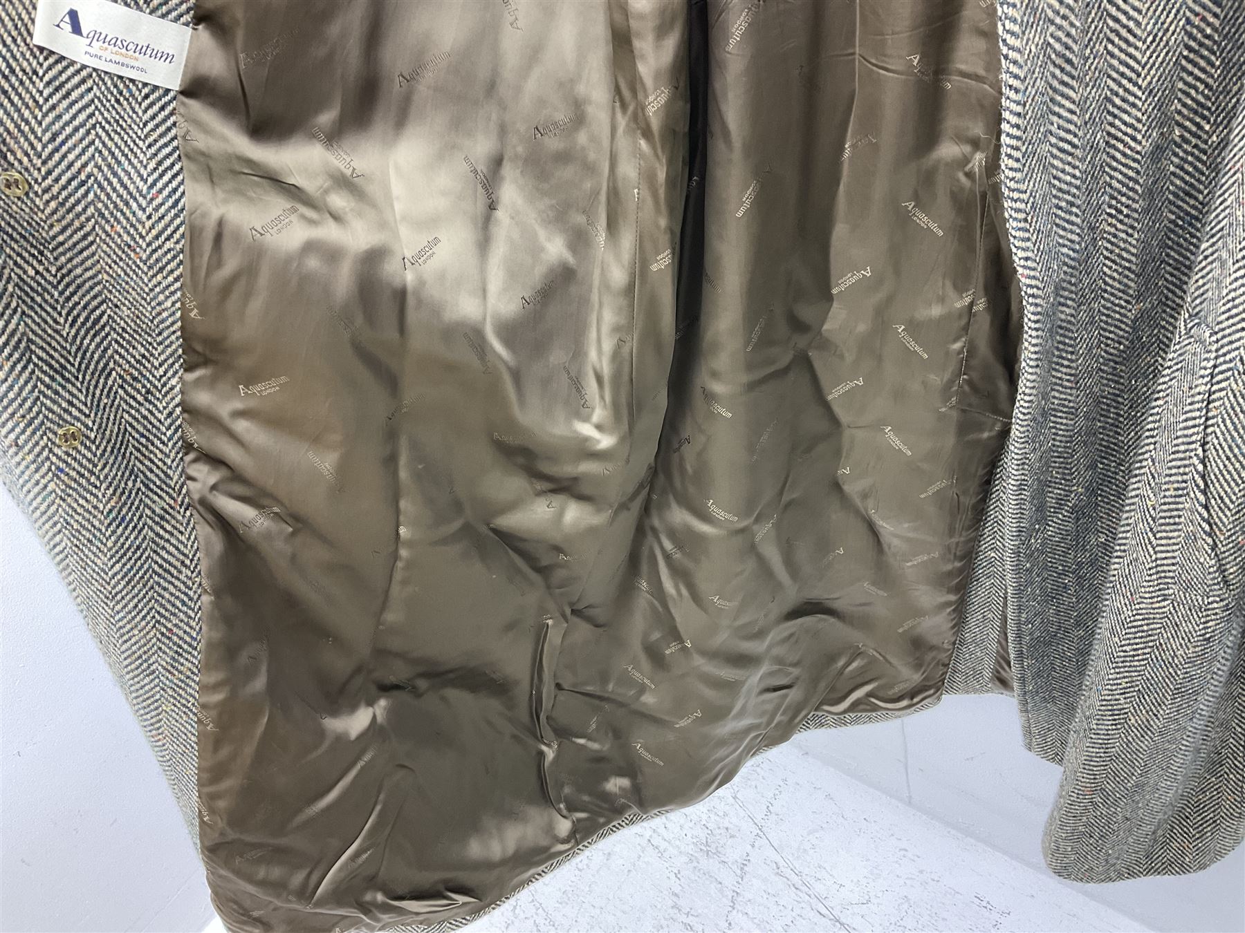 Men's Aquascutum lambs wool herringbone tweed coat with silk lining, 46 Reg, together with a further Men's Aquascutum grey wool duffle coat, with cheque lining and horn buttons, 46