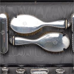 Early 20th century ladies leather travelling dressing case marked Walker & Hall, with watered silk interior and contents of silver mounted glass jars, dressing table set, leather blotter etc and with outer canvas London 1921/22 Maker Thomas Ingleton 46cm x 31cm 