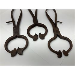 Three pairs of Georgian wrought iron spring loaded sugar nips each terminating in curved blades, one missing the spring, H22cm